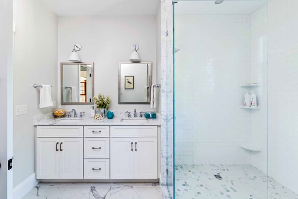 White bathroom renovation with glass shower door