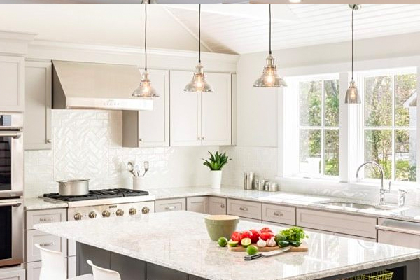 Kitchen renovation with marble island and white cabinets
